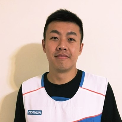 A person in a sports vest smiling at the camera
