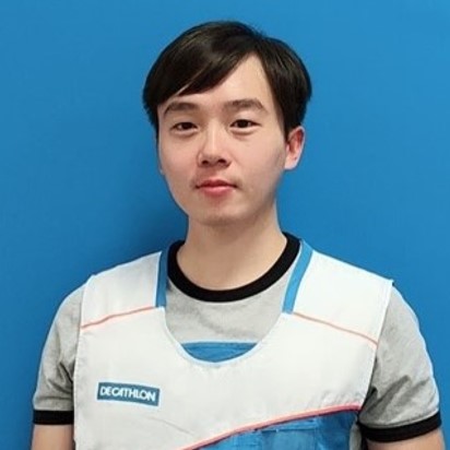Person wearing a Decathlon vest against a blue background