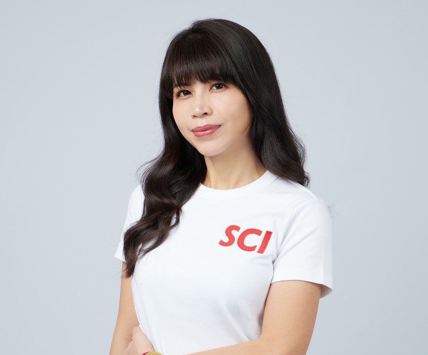 Person with black hair wearing a white T-shirt with red letters.