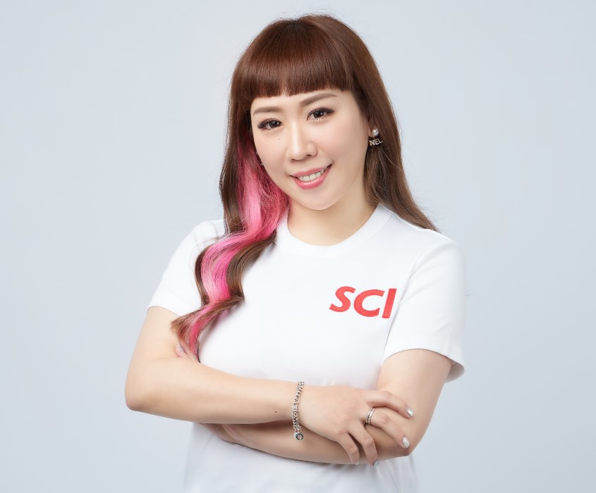 Person with pink hair streak wearing a white shirt