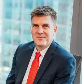 Person in a suit sitting in an office setting