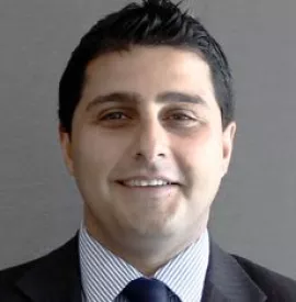 Portrait of a smiling person in a suit