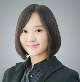 Portrait of a smiling individual in a suit jacket.