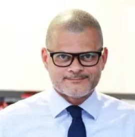 Adult wearing glasses, shirt, and tie