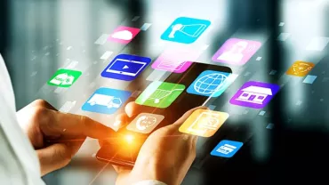 Person using a smartphone with app icons displayed.