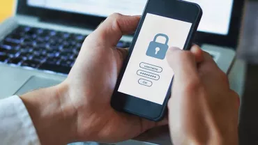 Person holding a smartphone with a lock screen and password entry interface visible.