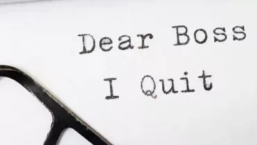 Text on paper reads 'Dear Boss, I Quit'.