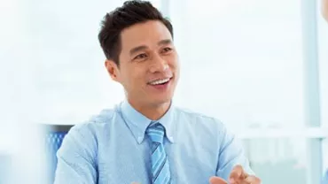 Two people having a conversation in a bright office.