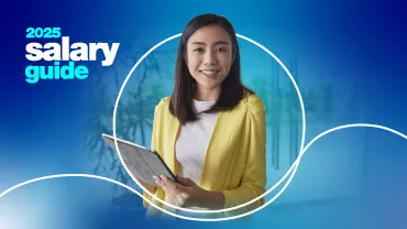 2025 salary guide woman smiling and holding clipboard