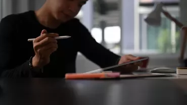 A professional drafting a resignation letter with a template during their job change process.
