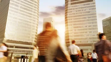 City skyscrapers with blurred pedestrians.