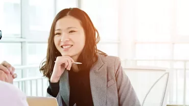 Two people having a conversation in a bright office