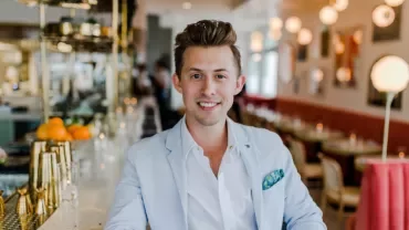 A person smiling in a restaurant