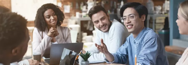 A group of people having a relaxed meeting around a table.