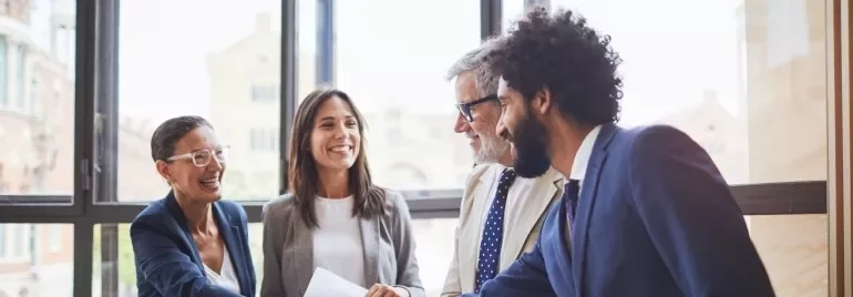 A handshake between business colleagues in an office, illustrating a moment of agreement and professional connection.