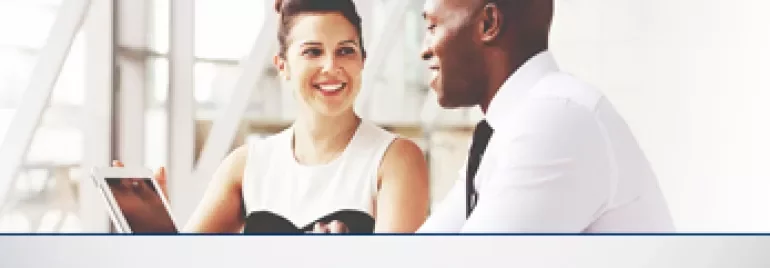 Two people having a conversation in an office setting.