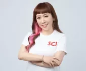 Person with pink hair streak wearing a white shirt