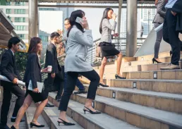 Executive speaking on her phone while walking up stairs