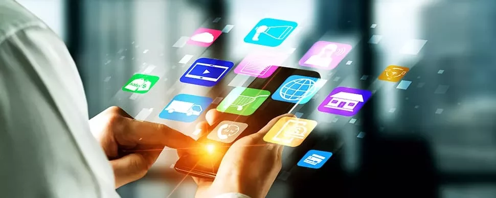 Person using a smartphone with app icons displayed.