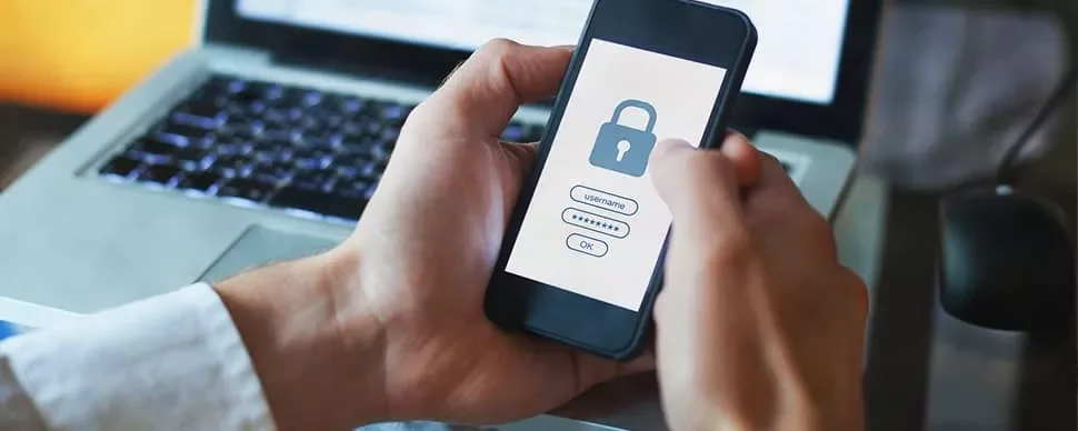 Person holding a smartphone with a lock screen and password entry interface visible.