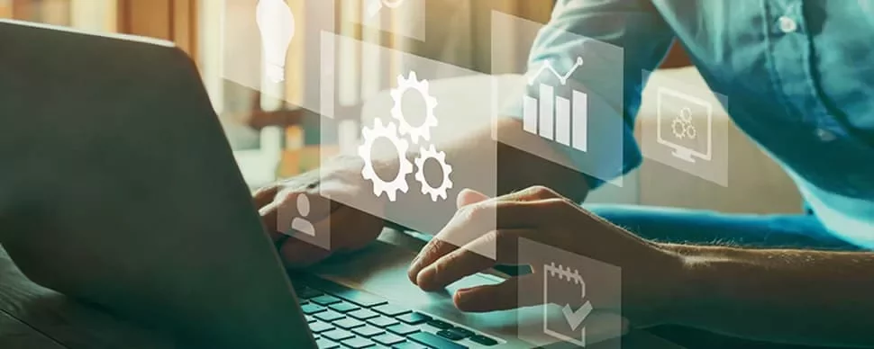 Person using laptop with digital icons overlay.