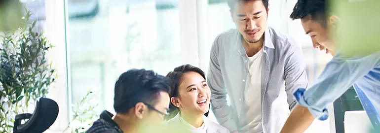 Group collaborating in a bright office setting.