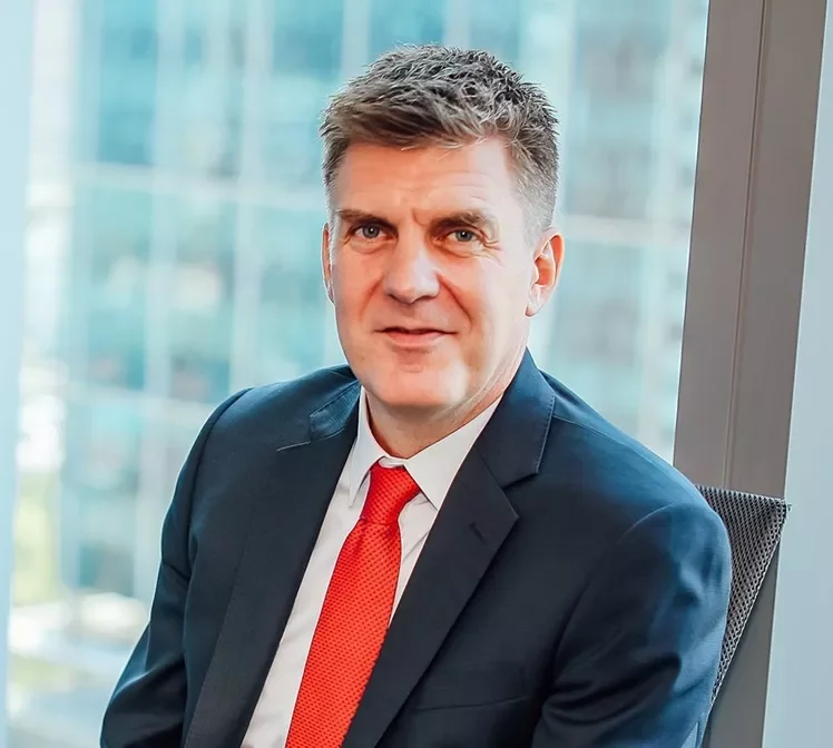 Person in a suit sitting in an office setting