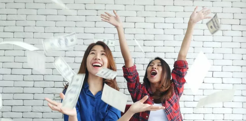 Two people enjoying throwing money in the air.