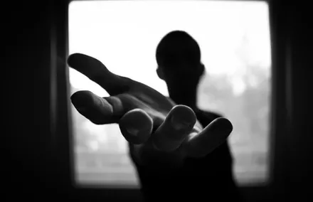 A hand reaching out towards the camera.